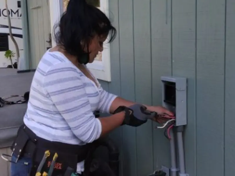 Licensed electrician wiring an exterior subpanel in Harding